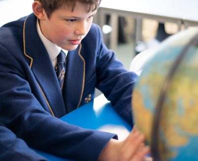 Rookwood private senior school student looking at a globe map