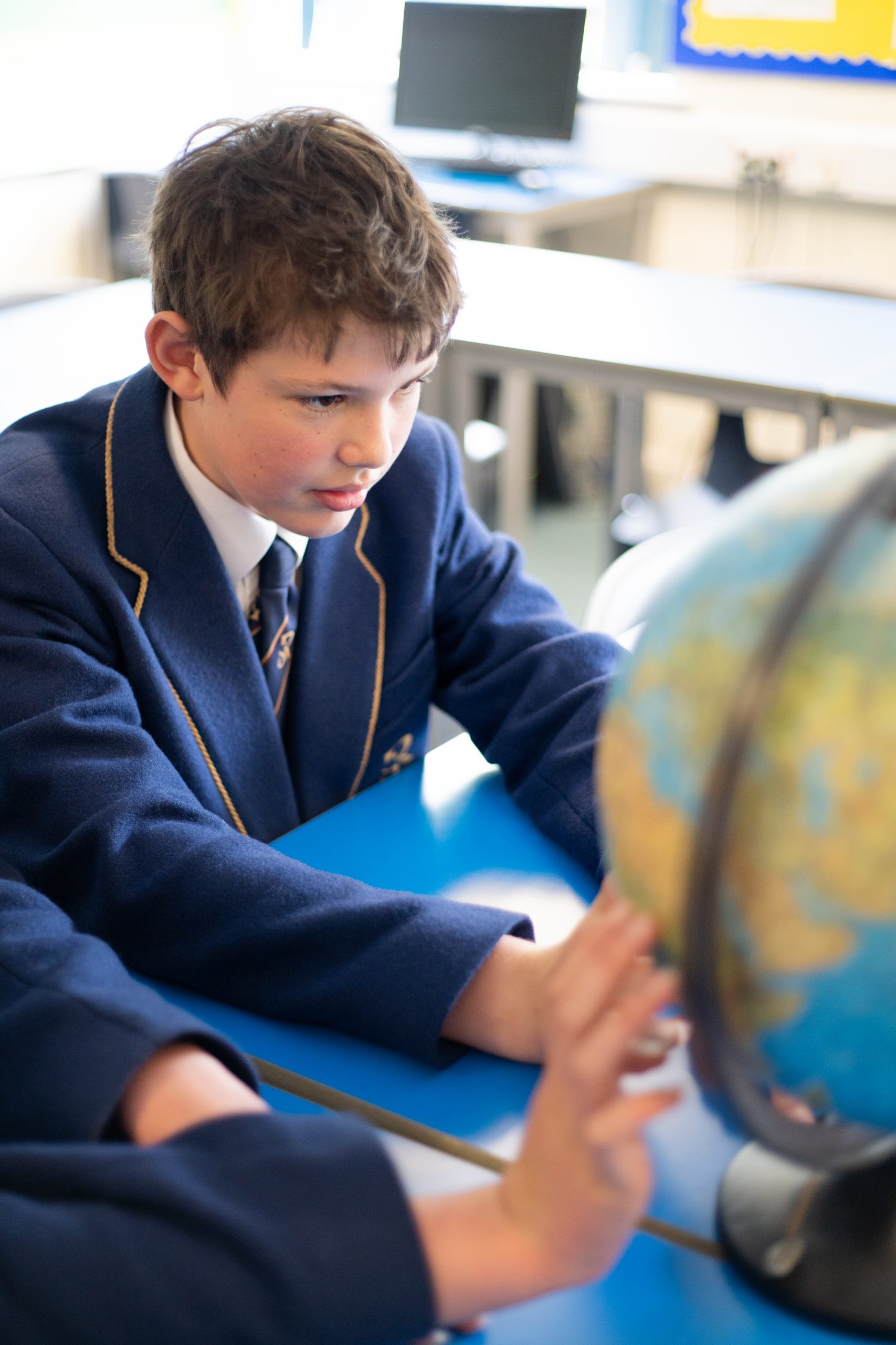 Rookwood private senior school student looking at a globe map