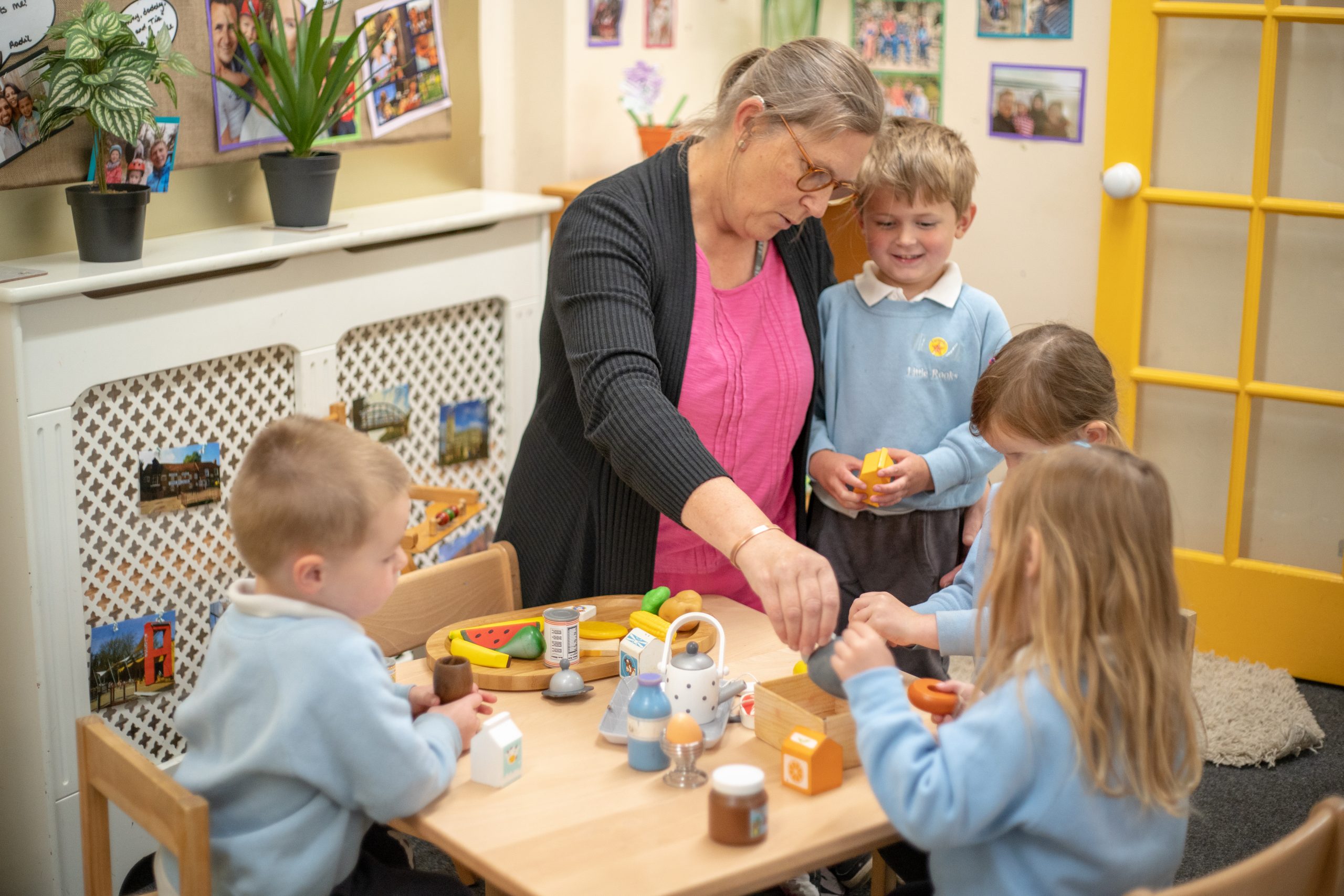 Rookwood Nursery school teacher sat with a table full of nursery pupils