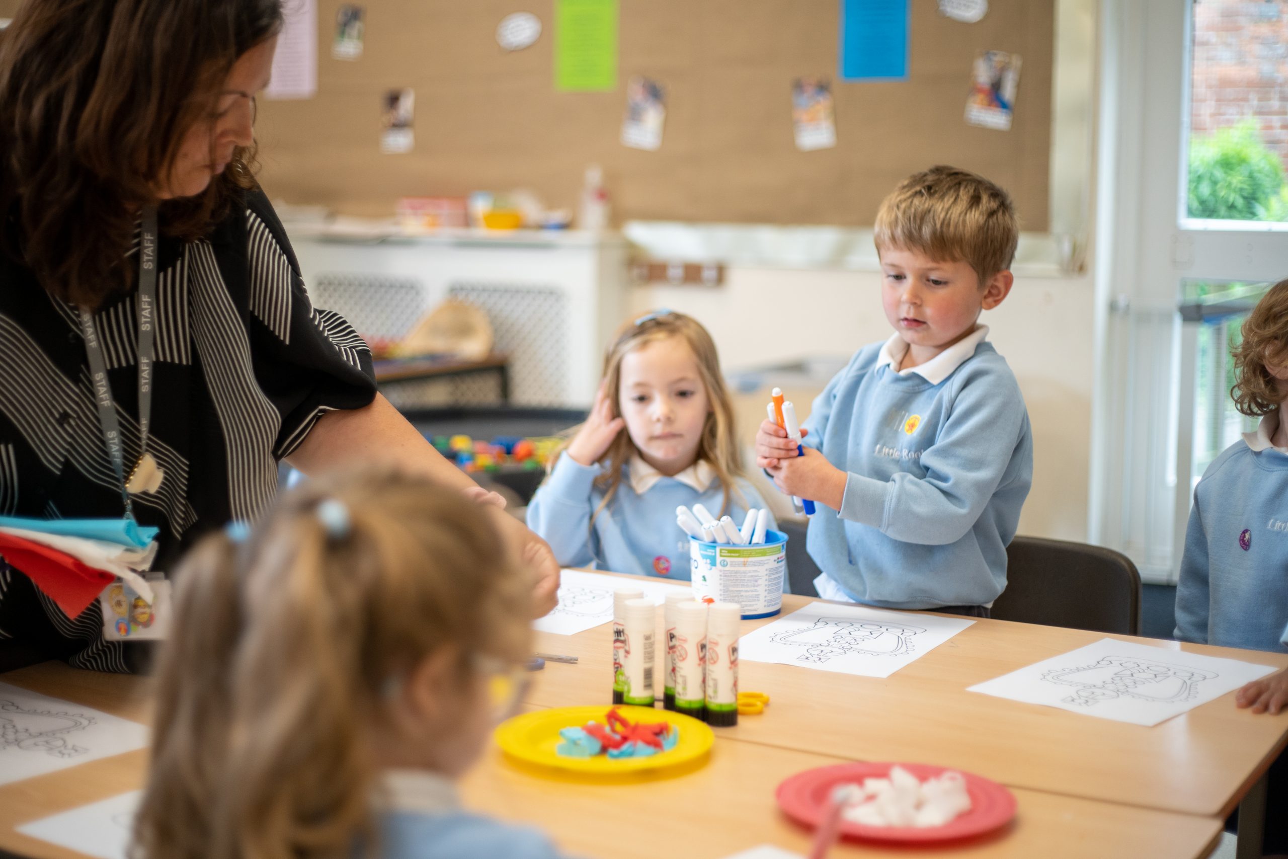 Rookwood Private Nursery teacher and children starting a colouring activity