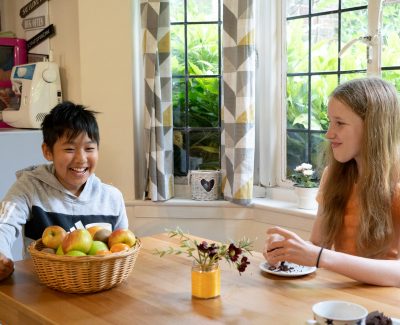 Rookwood school students sat at table in boarding accommodation