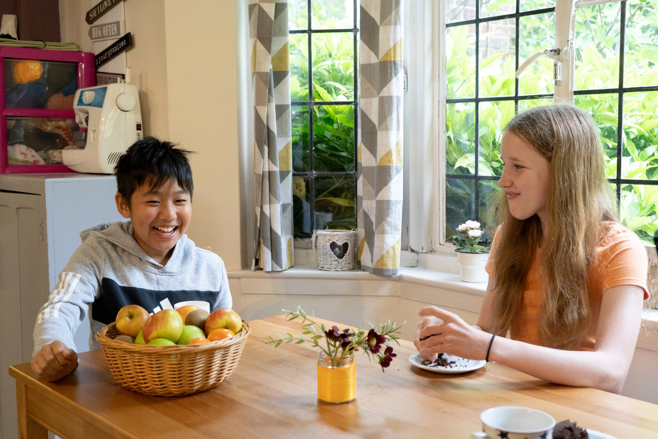 Rookwood school students sat at table in boarding accommodation