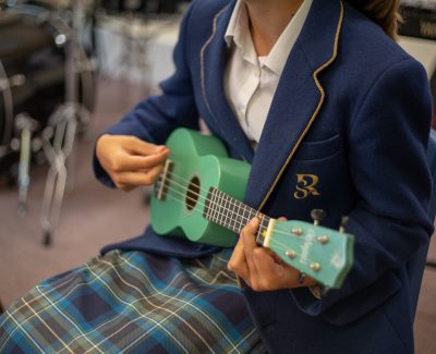 Rookwood School student playing the ukulele