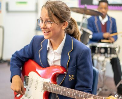 Rookwood School student playing an electric guitar