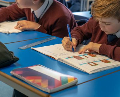 Rookwood School students sat at desks writing in their workbooks