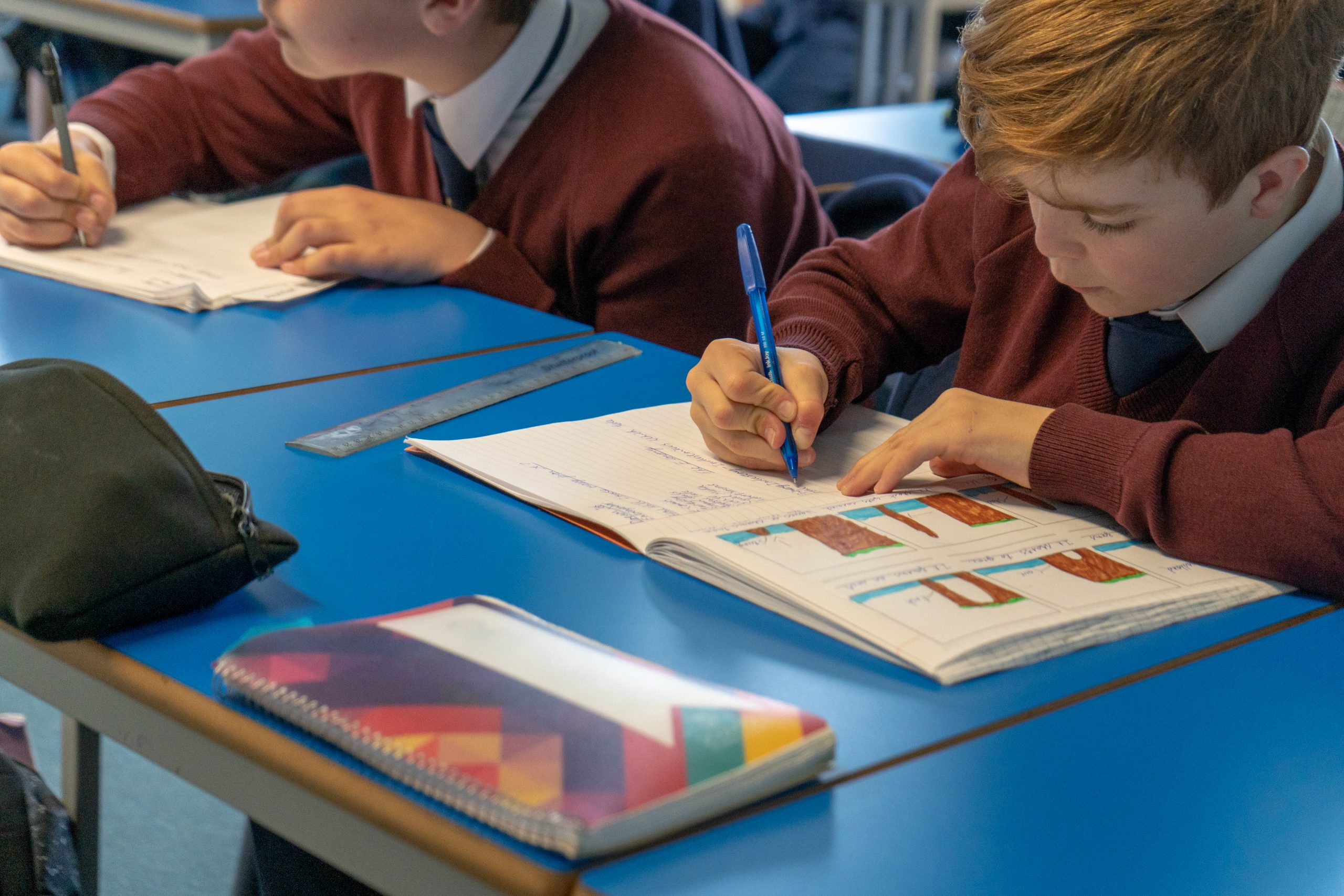 Rookwood School students sat at desks writing in their workbooks