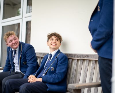 Rookwood senior school students talking to one another on an outside bench