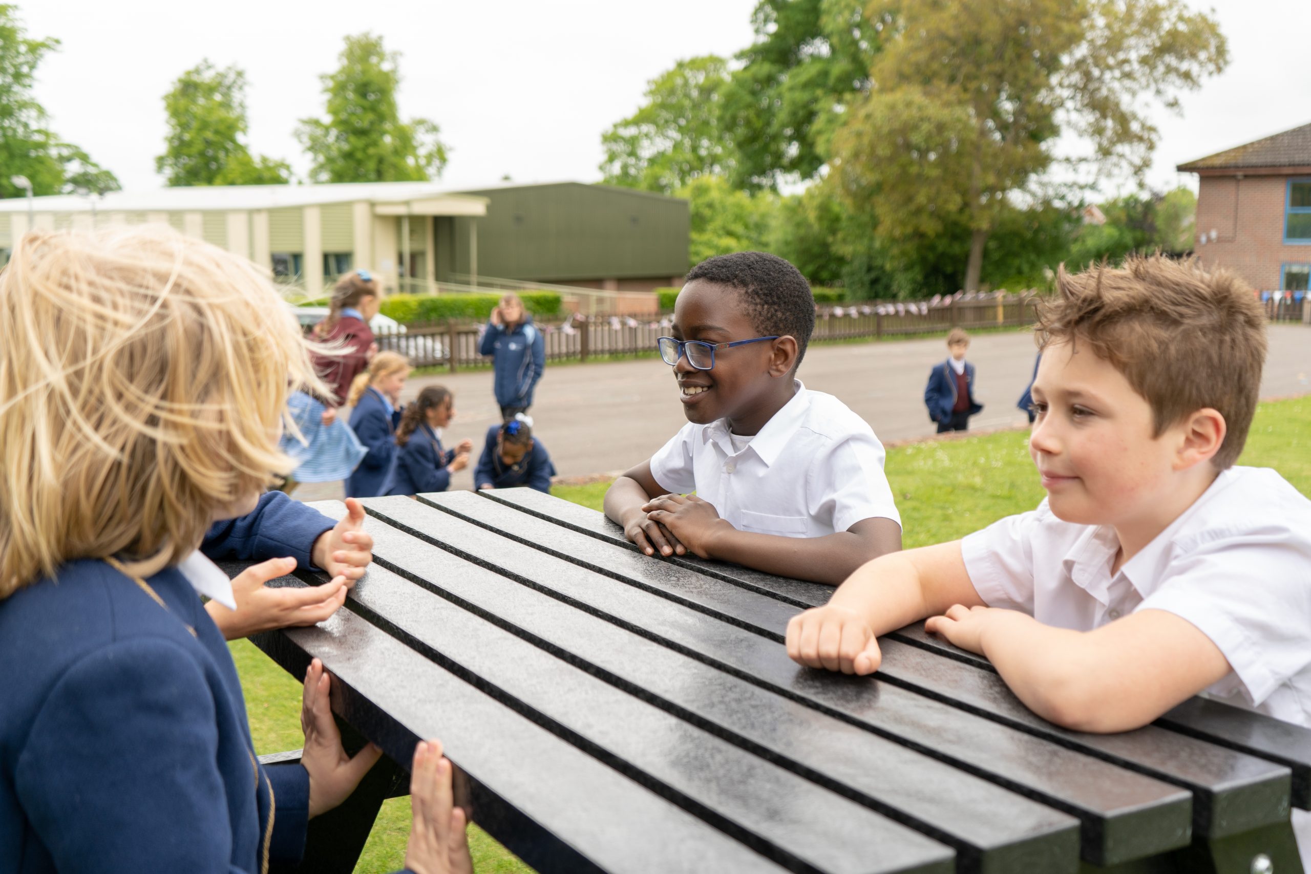 Rookwood private lower school students sitting on a bench