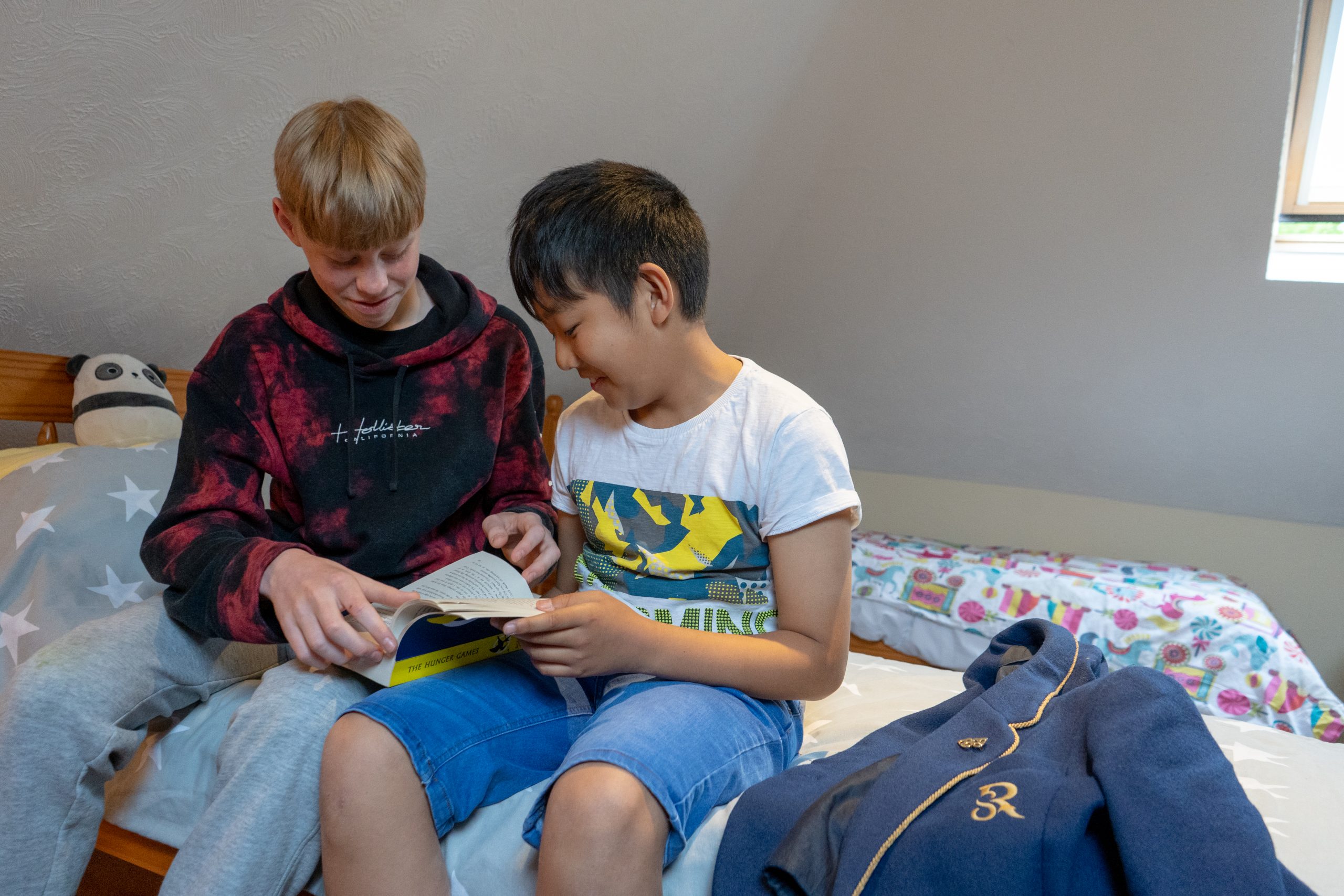 Rookwood School boarding students sat on bed reading a book