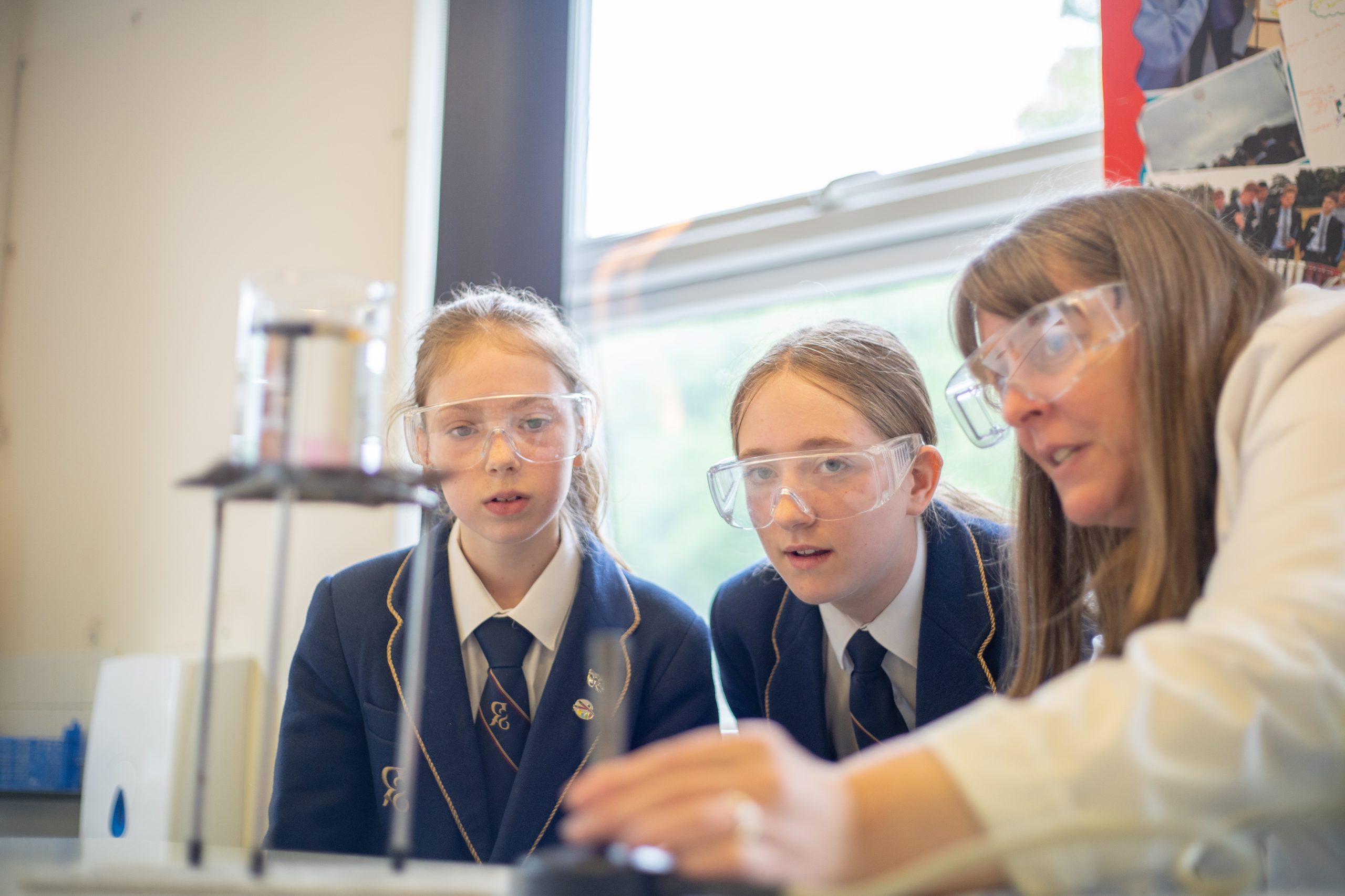 Rookwood School teacher using a bunsen burner while students watch intently