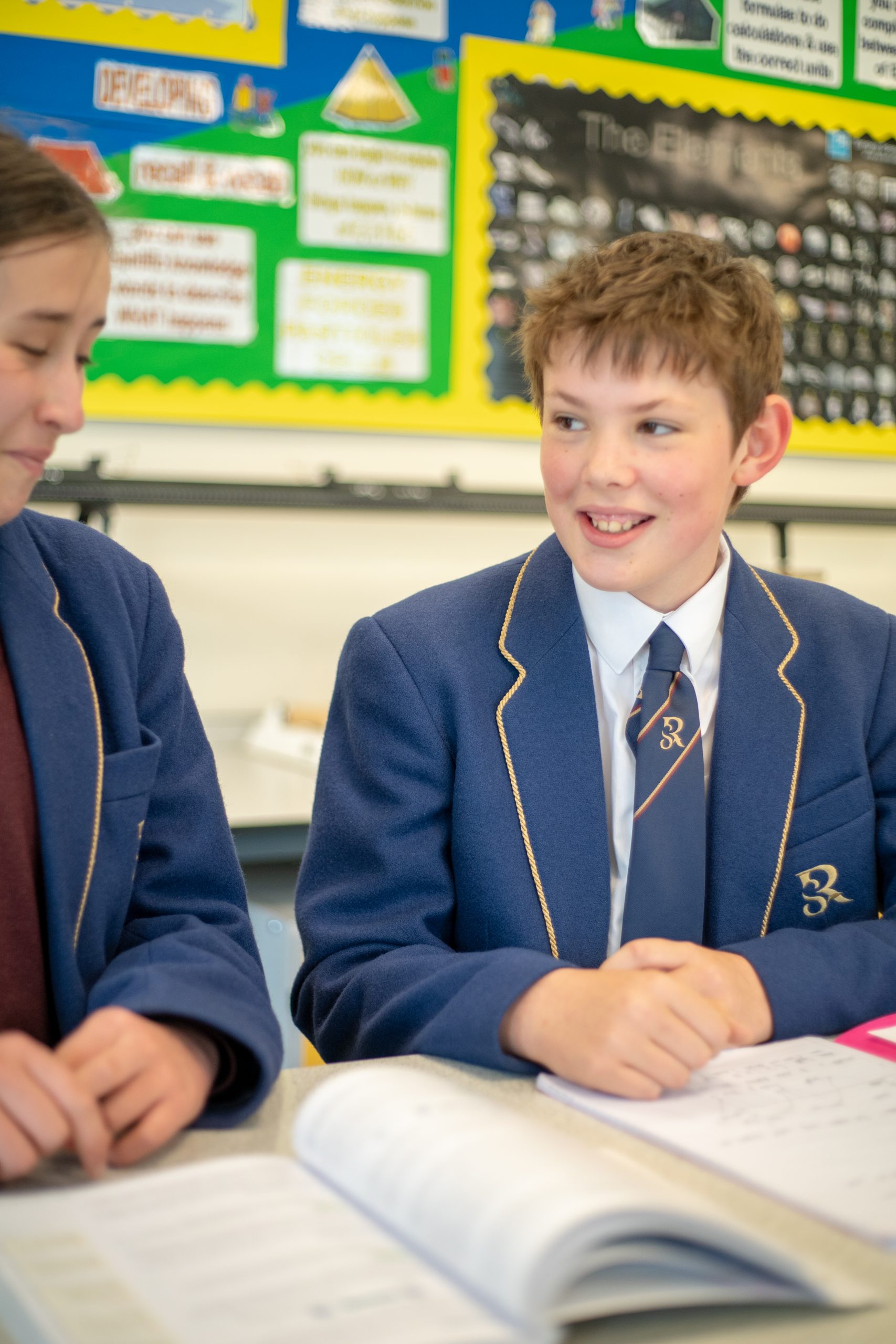 Rookwood School students smiling in class completing work