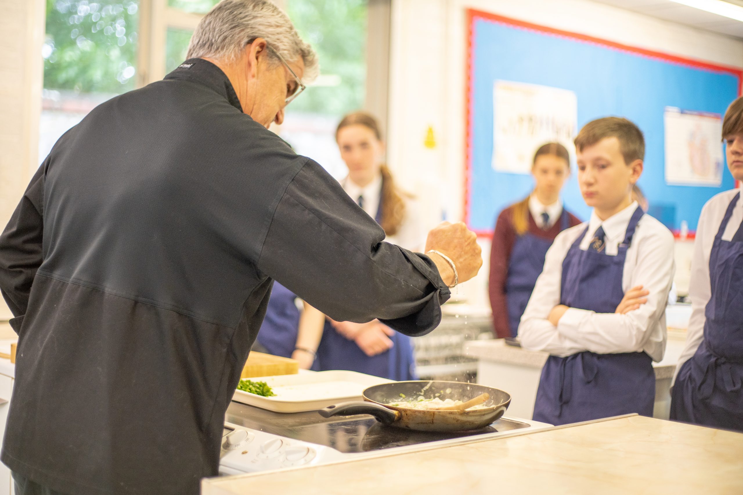 Rookwood Private School teacher demonstrating cooking to a class of students