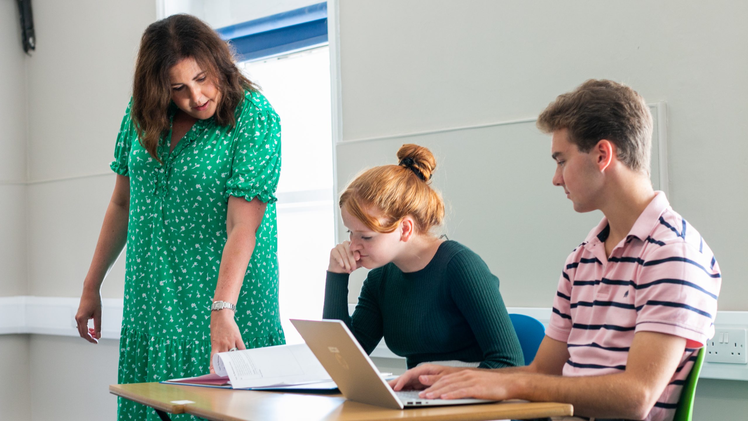 Rookwood School Sixth form students working at desk beside a teacher